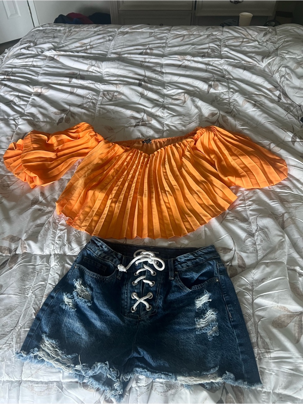 Bright Orange Pleated Off-Shoulder Women’s Top and denim shorts